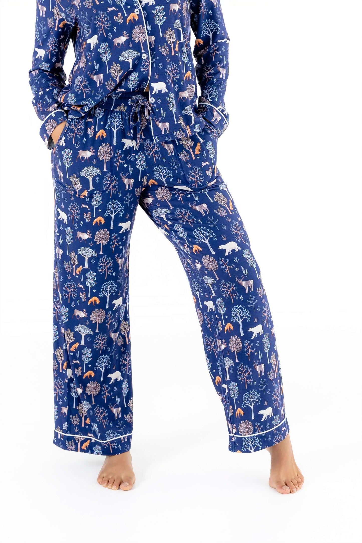 Women TENCEL Modal pajama set in Woodland Midnight print, showing soft long sleeve top and pants with forest motif, sustainable comfort.