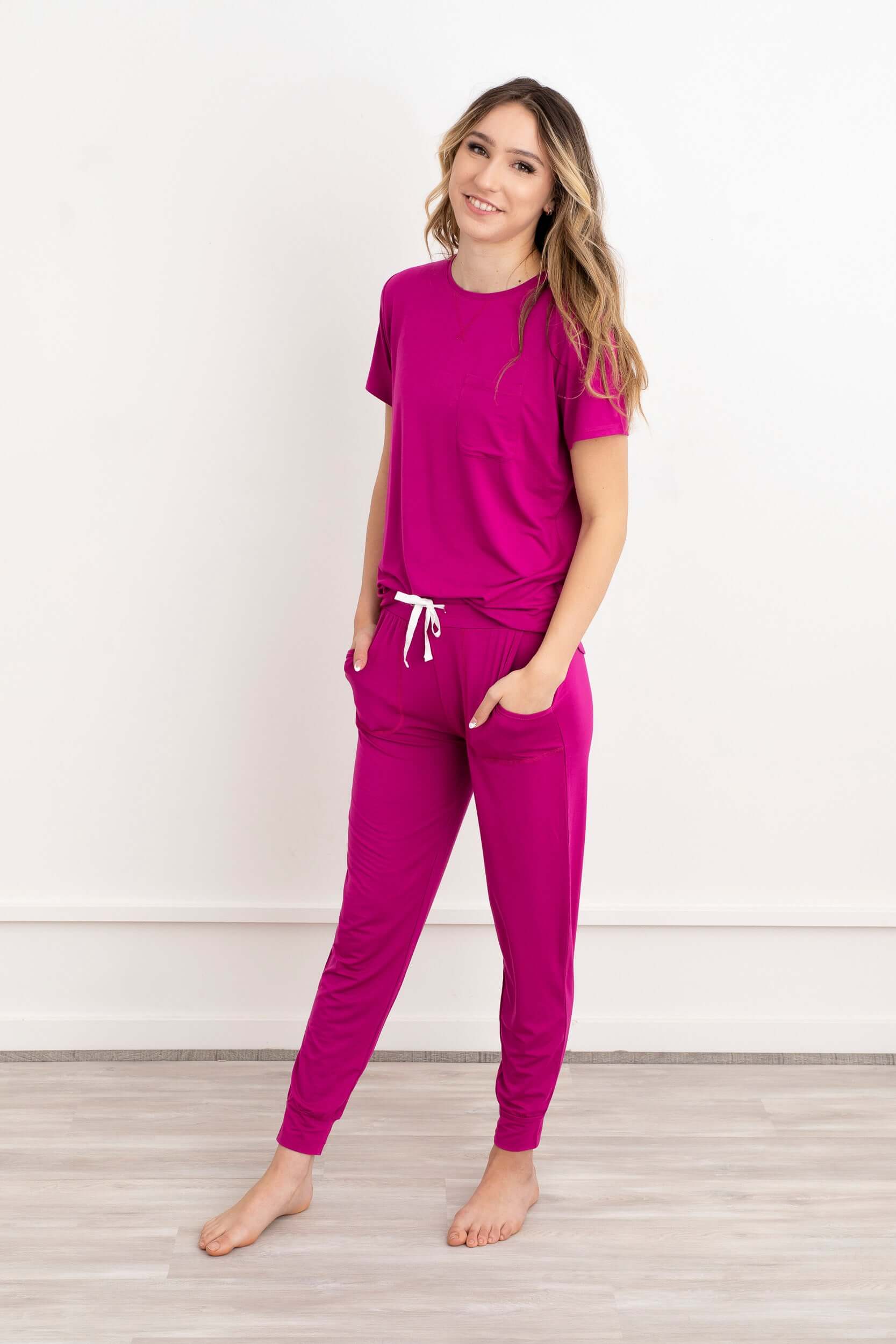 In this photo, a girl exudes casual elegance in our Rosy Pink Modal Short Sleeve and Pants Pajama Set. The soft, breathable fabric drapes gracefully, offering both comfort and style. The cool rosy hue adds a touch of sophistication to her relaxed ensemble