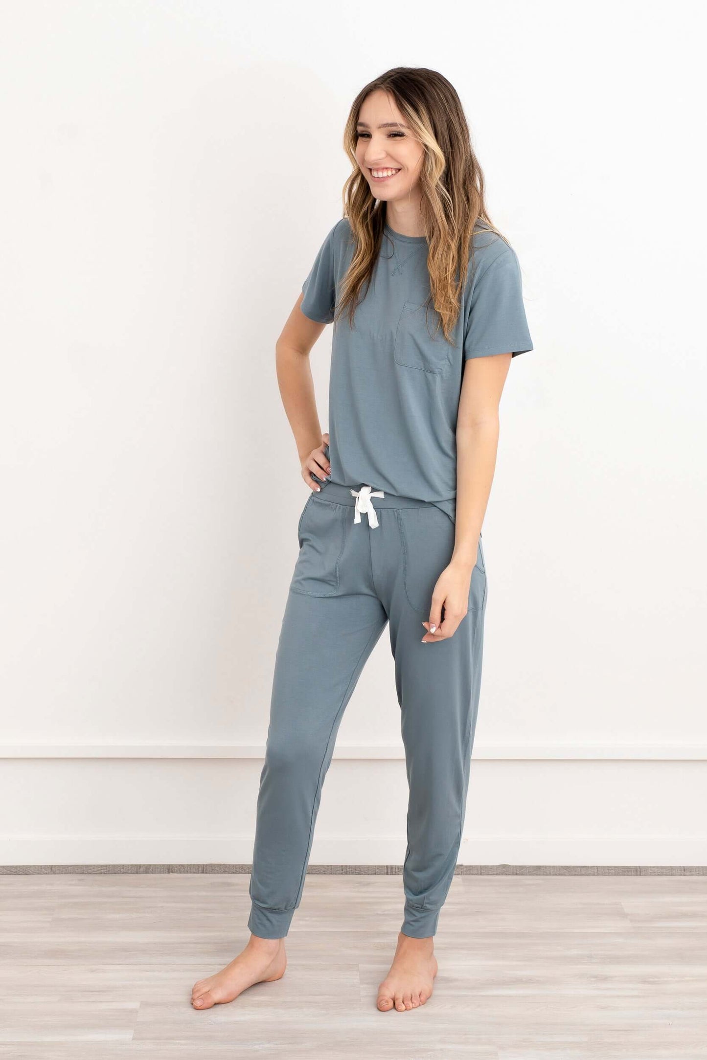 In this photo, a girl exudes casual elegance in our Blue-Gray Modal Short Sleeve and Pants Pajama Set. The soft, breathable fabric drapes gracefully, offering both comfort and style. The cool blue-gray hue adds a touch of sophistication to her relaxed ens