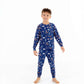 Front view of child wearing kids pajama set in Woodland Night forest print