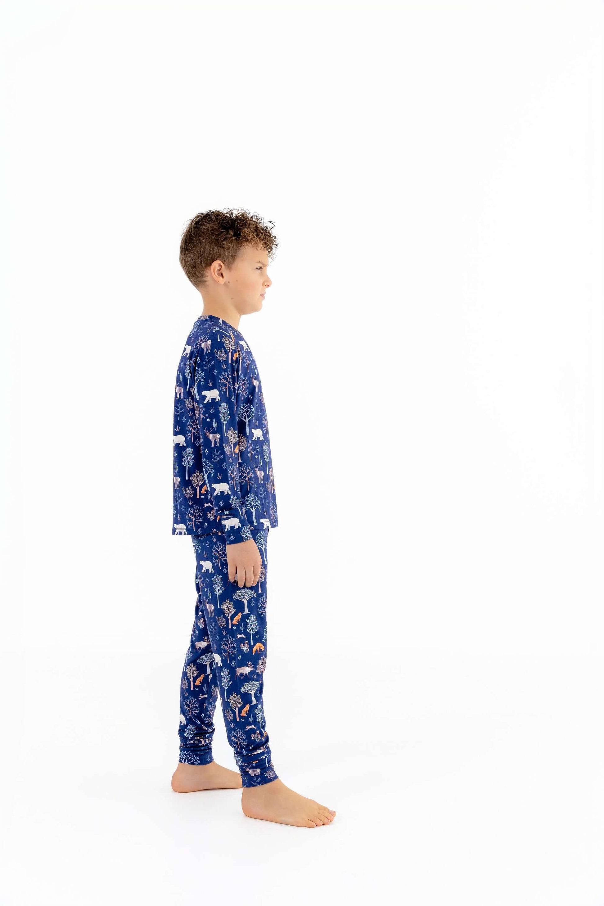 Side view of child modeling soft modal kids pajama set in Woodland Night