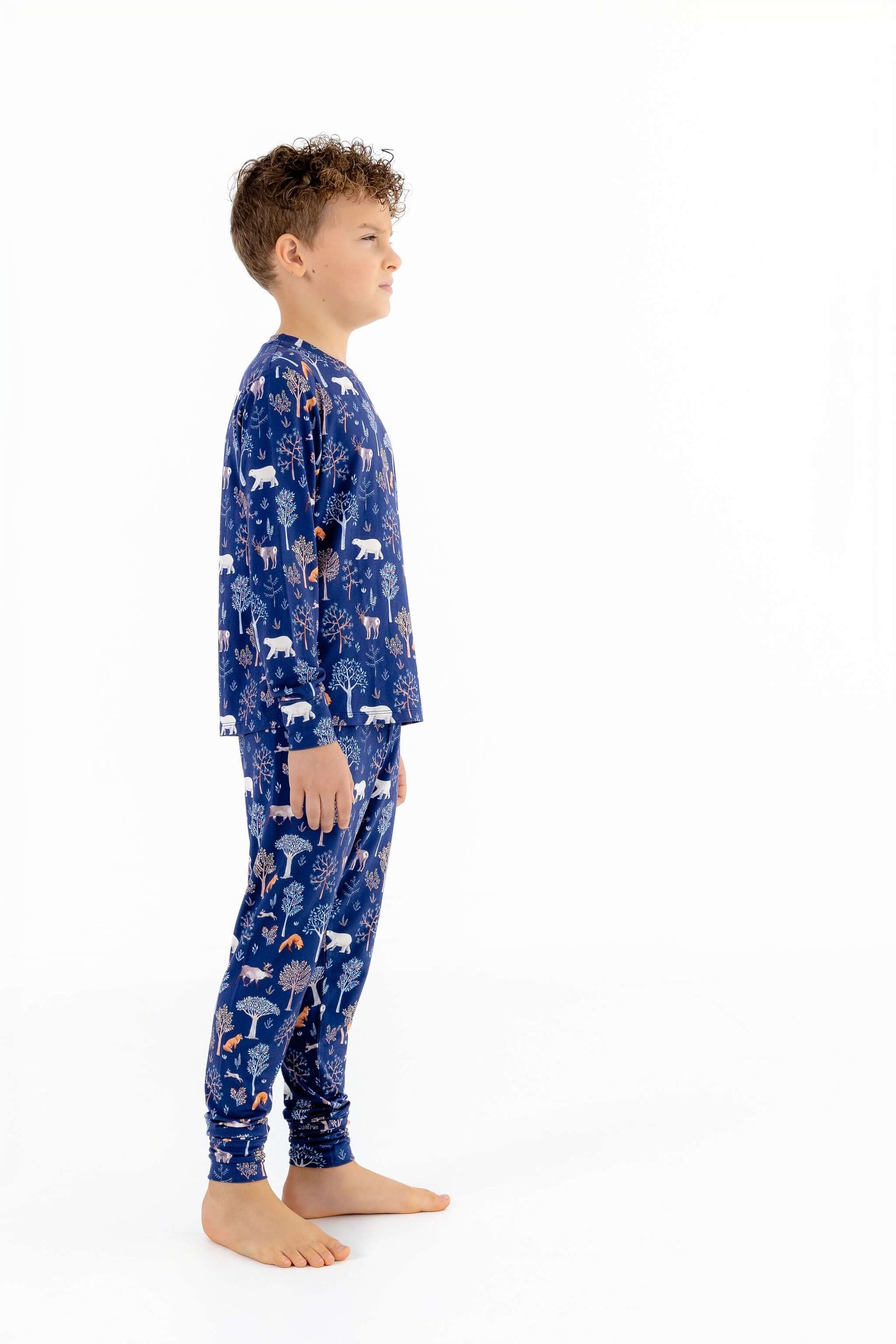 Side view of child modeling soft modal kids pajama set in Woodland Night