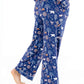Woman wearing Women TENCEL Modal Pajama Set Woodland Midnight with forest pattern, showcasing soft, sustainable, and breathable material.