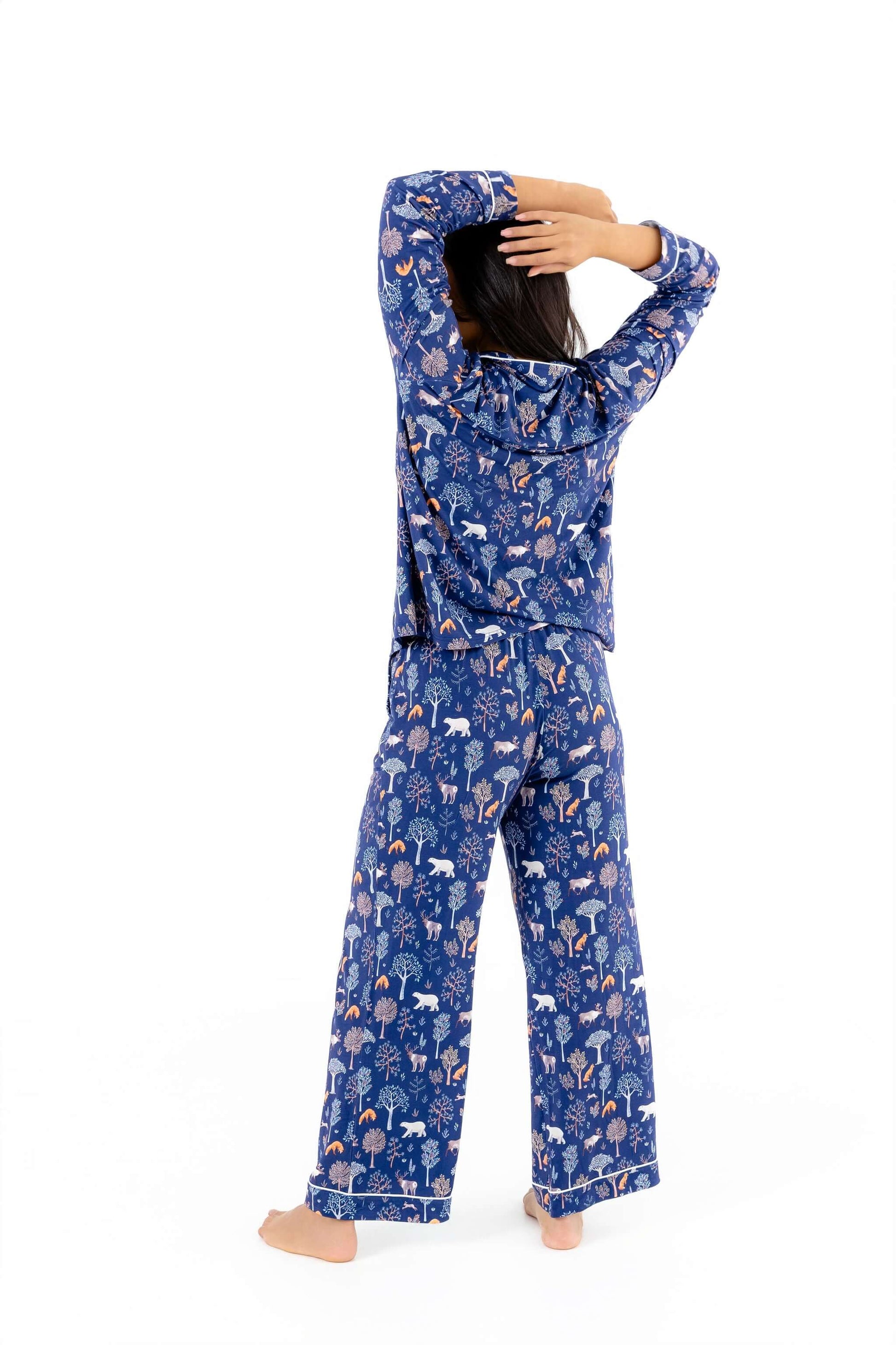 Woman wearing Women TENCEL Modal pajama set in Woodland Midnight print, showcasing long sleeve and sustainable comfort.