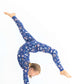 Kids pajama set made from stretchy modal shown as girl cartwheels in Woodland Night print