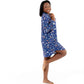 Smiling woman in a blue floral Woodland Night women nightshirt long sleeve, showcasing comfort and style.